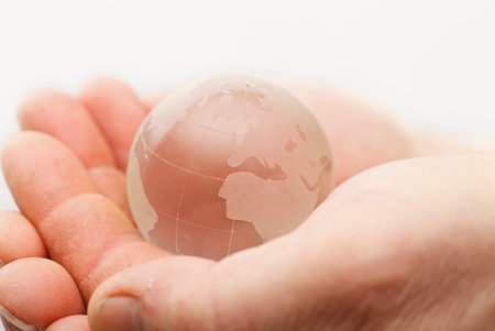 Closeup of a glass globe holding in handsの写真素材