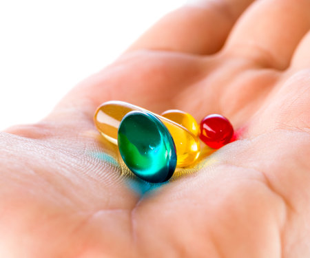 Closeup photo of colorful pills in handの写真素材