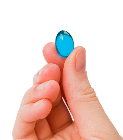 Closeup photo of blue gel capsule in handの写真素材