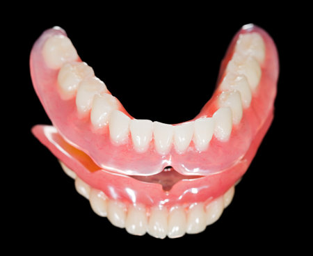 Artificial lower denture on isolated  black background