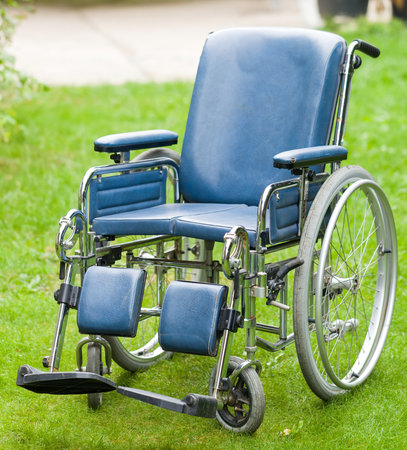 Photo of a wheelchair on green grassの写真素材