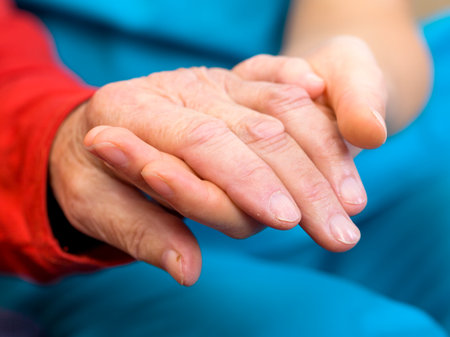 Young carer giving helping hands for elderly womanの写真素材