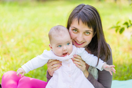 Portrait of an adorable baby with her motherの写真素材