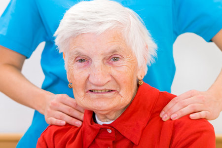 Photo of elderly woman supported by young doctorの写真素材
