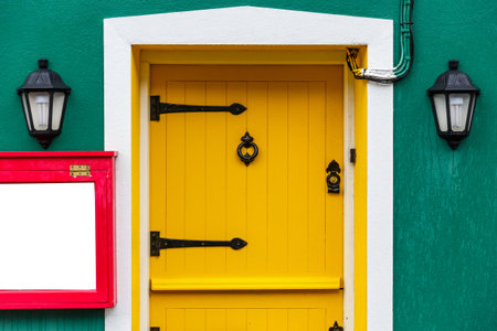 Photo of a yellow front door and two decor lamps Photo of a yellow front door and two decor lamps