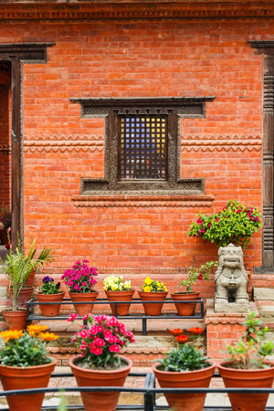 Photo of carved wooden window on a brick wallの写真素材