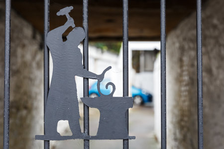 Photo of symbolic blacksmith on iron fenceの写真素材