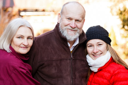 Happy elderly couple with the young carerの写真素材