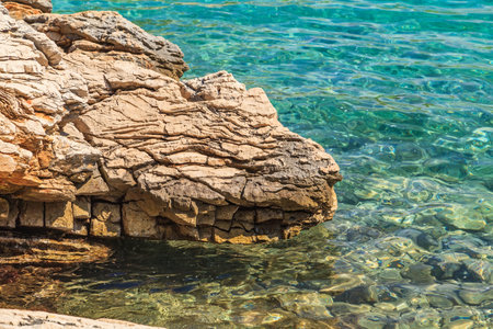 Landscape photo of rocky adriatic shore and crystal clear waterの写真素材