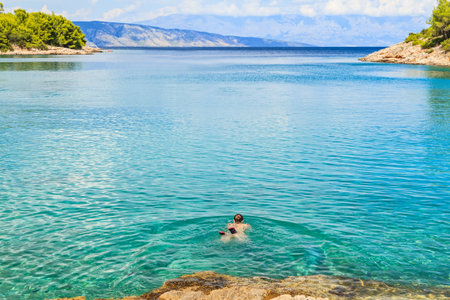 Young woman swimming in the mediterranean seaの写真素材