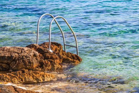 Photo of handrail on rocky adriatic coastlineの写真素材