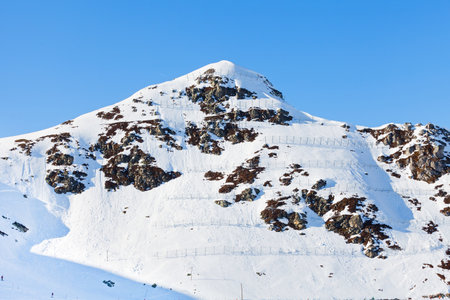 Photo of snowy mountains with avalanche protection barriersの写真素材