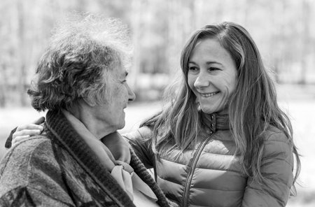 Portrait photo of happy elderly woman with her daughter