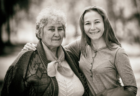 Portrait photo of happy elderly woman with her daughterの写真素材