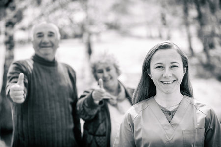 Photo of elderly couple and young caregiverの写真素材