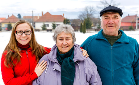 Photo of happy elderly couple and young caregiverの写真素材