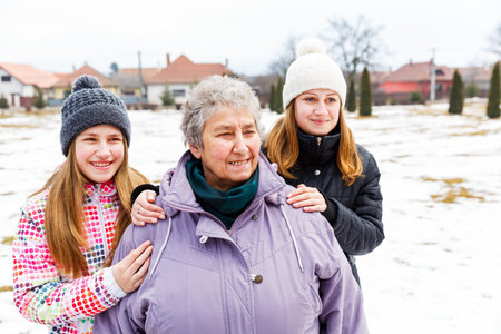 Photo of happy elderly woman and granddaughters