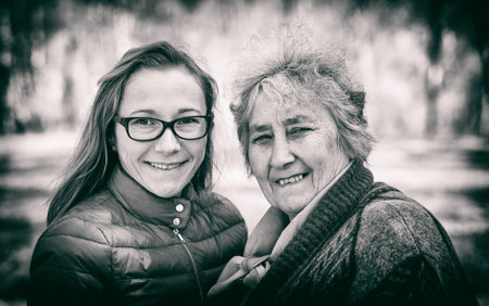 Portrait photo of happy elderly woman with her daughter