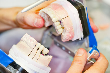 Close up photo of dental technician working on a tooth crown