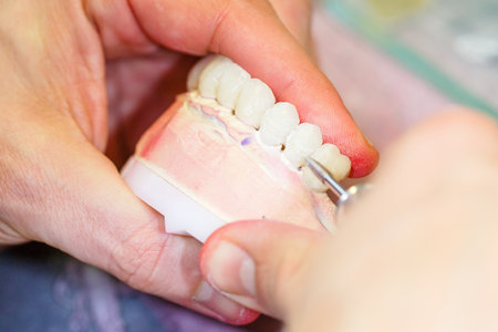 Close up photo of dental technician working on a tooth crown