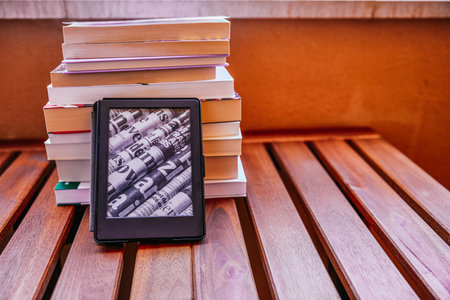 ebook on mountain of books, bookstore with an e-book, ecologyの写真素材
