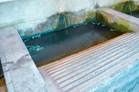Close-up of a covered old stone washhouseの写真素材