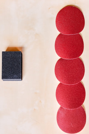 Vertical photo of round and scouring pad sandpaper for woodworking with copyspaceの写真素材