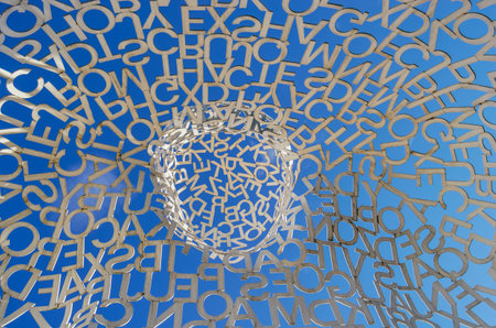 Swarm of white letters in the shape of a wall with blue skyの写真素材