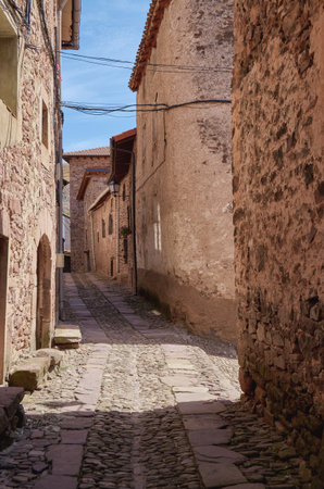 Cobblestone street in the middle of an ancient Spanish villageの写真素材