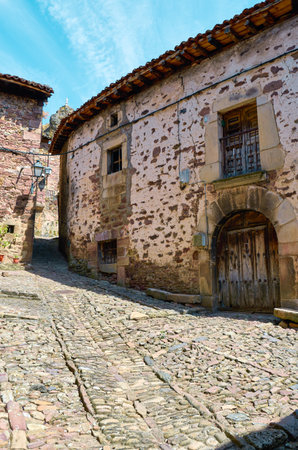 Cobblestone street in the middle of an ancient Spanish villageの写真素材