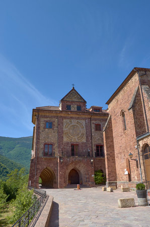 Mountain abbey with blue sky and green forestの写真素材