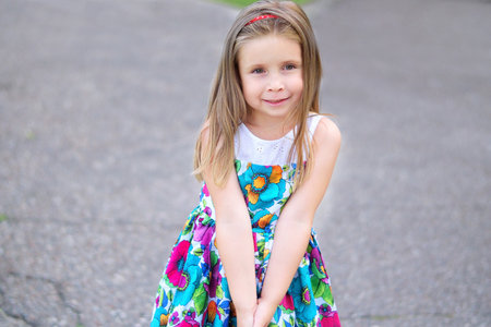 Adorable little girl smiling in a parkの写真素材