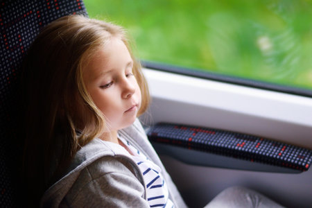 Adorable little girl going on vacations and traveling by railway.の写真素材