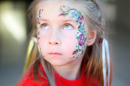 Adorable girl with painted face by animatorの写真素材