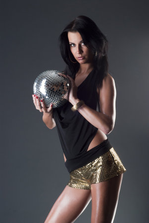 Sexy lady with shiny disco ballの写真素材