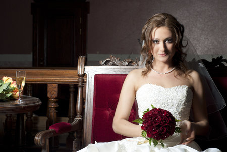 Beautiful bride sitting on a sofaの写真素材