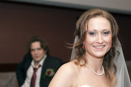 Smiling bride and groom behind herの写真素材