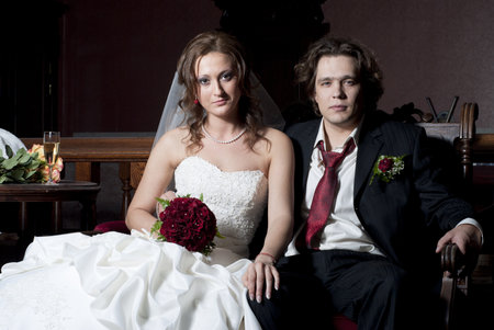 Beautiful bride and groom sittingの写真素材
