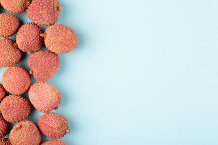 Lychee on a blue background, flat lay, copy spaceの写真素材