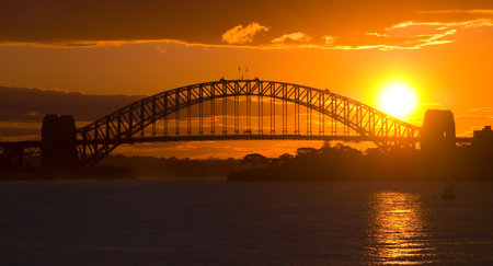 Sunsets behind Sydney Harbor ( Harbour ) Bridge - a deep golden orange sunsetの写真素材
