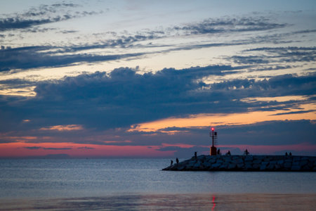 Seascape at sunset. Lighthouse on the coastの写真素材