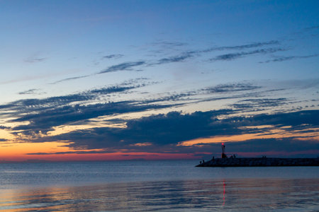 Seascape at sunset. Lighthouse on the coastの写真素材