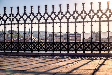 Sunset. Reflection of the lattice fencing. Danube Embankment in Budapestの写真素材