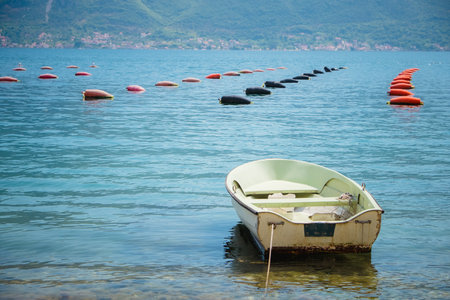 fishing boat on an oyster farm in the Bay of Kotor, Montenegro