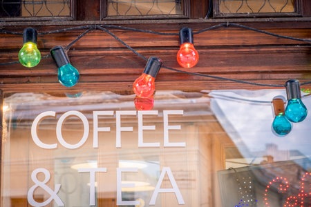 colorful Christmas lightsbulb on window of cafeの写真素材