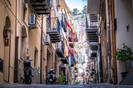CEFALU, ITALY - October 03, 2019: Old town street with balconies and clothesのeditorial素材