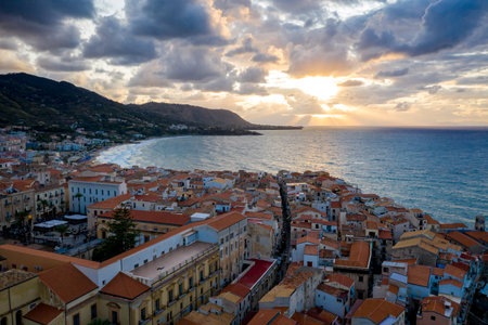 Panorama view on night cityscape of Cefalu from the sea. Tyrrhenian Sea. Sicily, Italy
