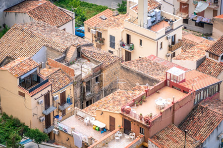 Panorama view on cityscape of Cefalu from drone. Roofs of houses with terraces close-up. Sicily, Italyの写真素材