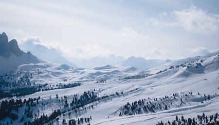 Landscape at a ski resort Campitello di Fassa Italy. Winter Dolomites and blue sky with clouds.の写真素材