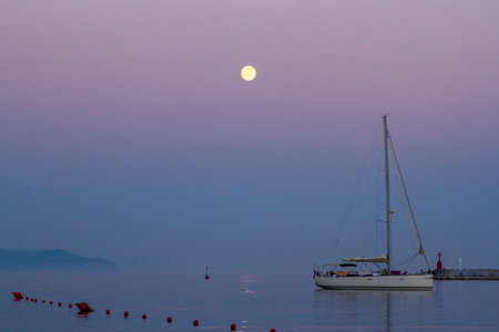 Santa Margherita Ligure. The italian Riviera near Portofino, a coastal city on the Italian Riviera in the Italian region of Liguria. Night landscape with a yacht and a full moonの写真素材